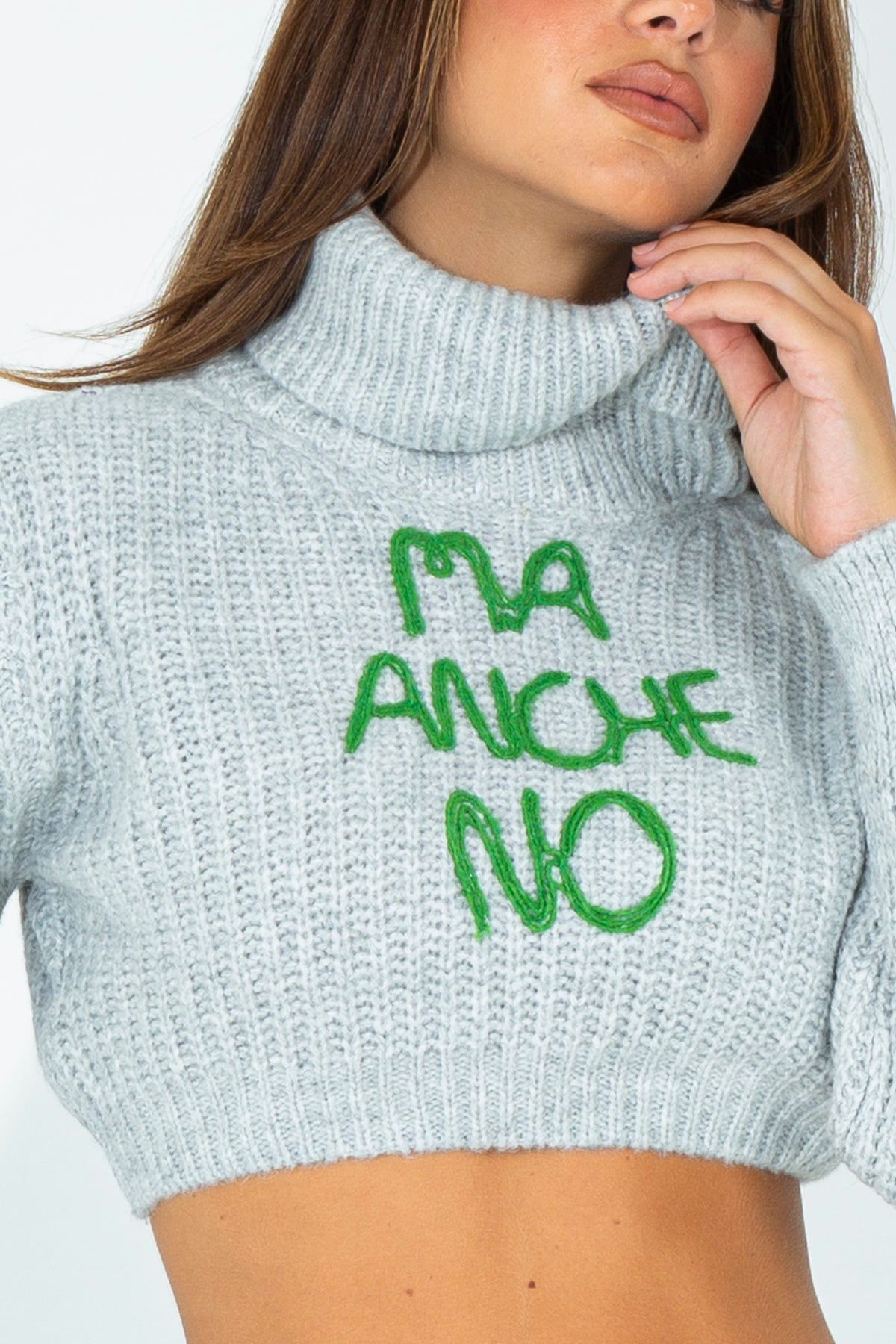 Crop turtleneck sweater with embroidered phrase